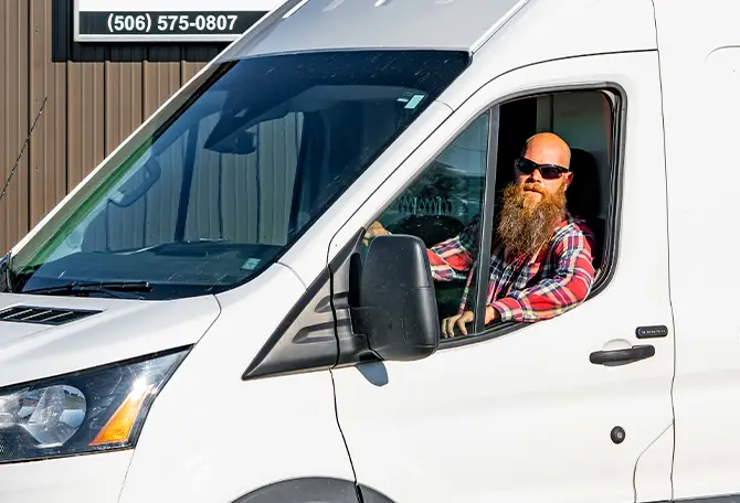 A service technician in his service truck, ready to help.
