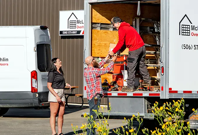 Team member helping a garage door technician
